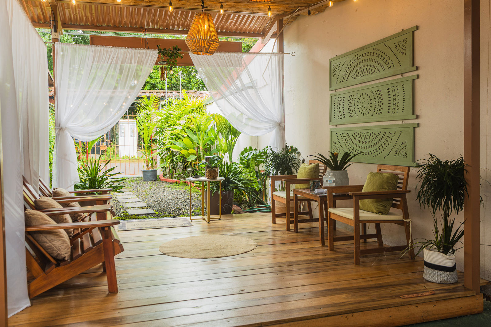 Spa welcome lounge with white drapes and tropical greenery